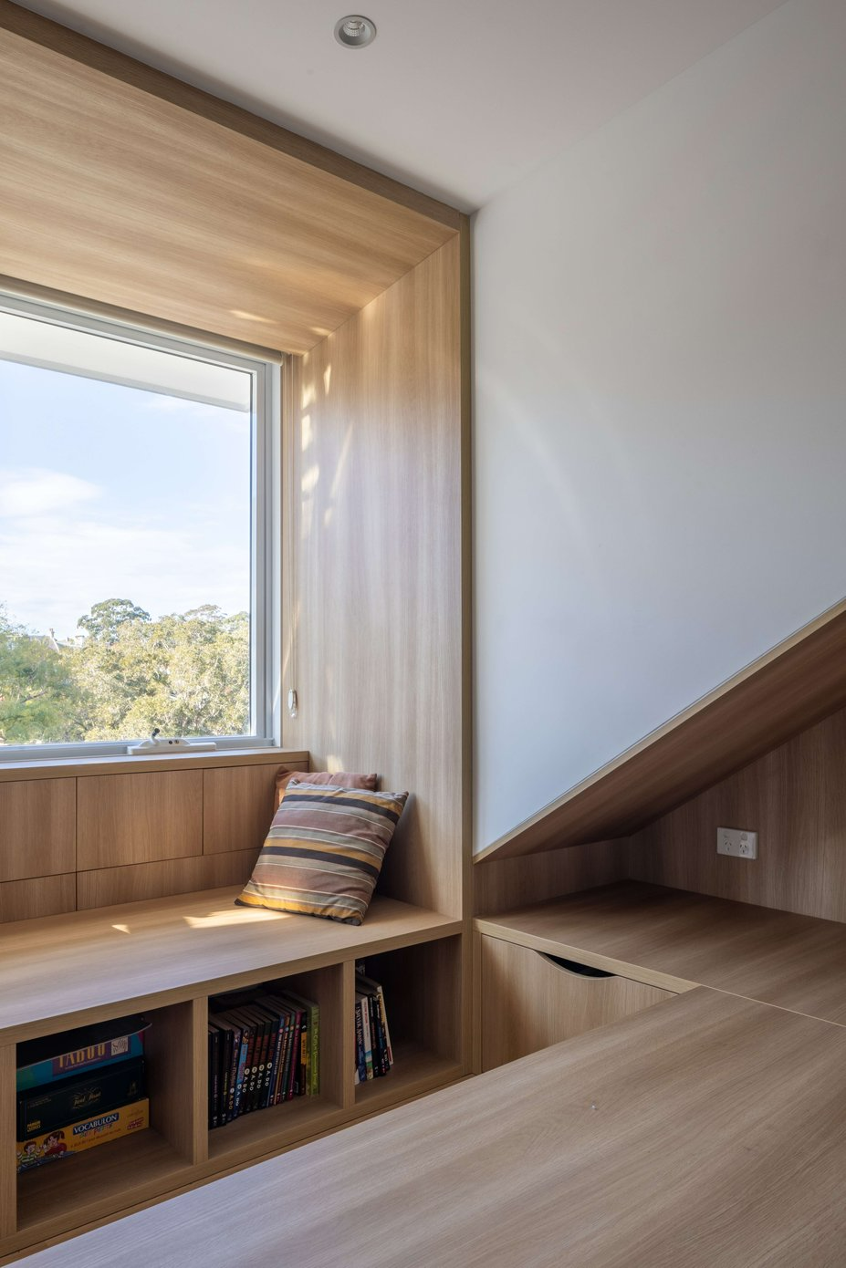 The Jacaranda Terrace, Paddington by Nathalie Scipioni Architects. Photography by Sarah Vita. Timber cabinetry, storage and window seat underneath louvered windows. 
