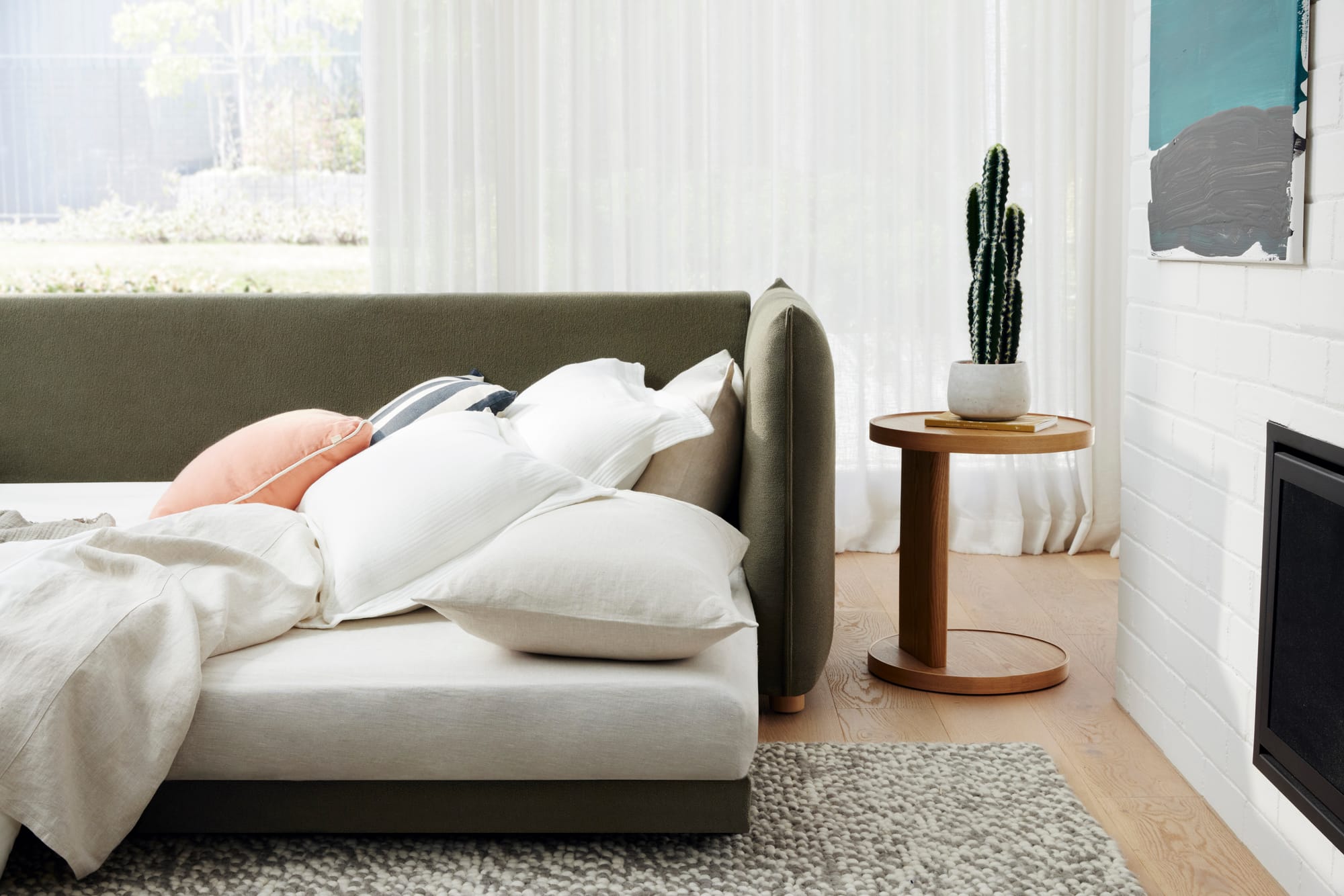 Koala's Byron Bay Sofa Bed in Green Wattle with a timber side table.