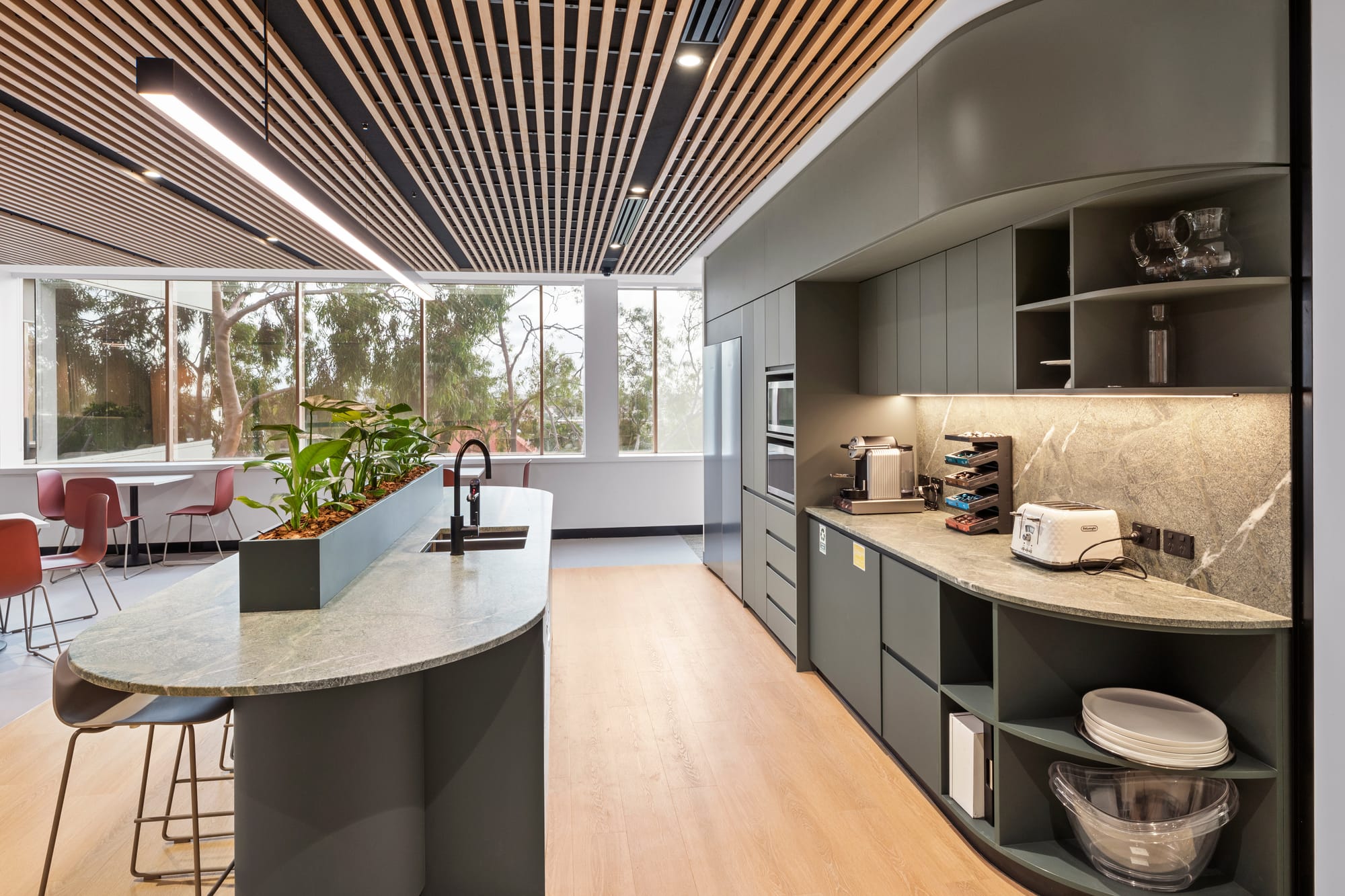 Steven Pooley of Saru Design.  Black and white image if man in checked shirt smiling. 