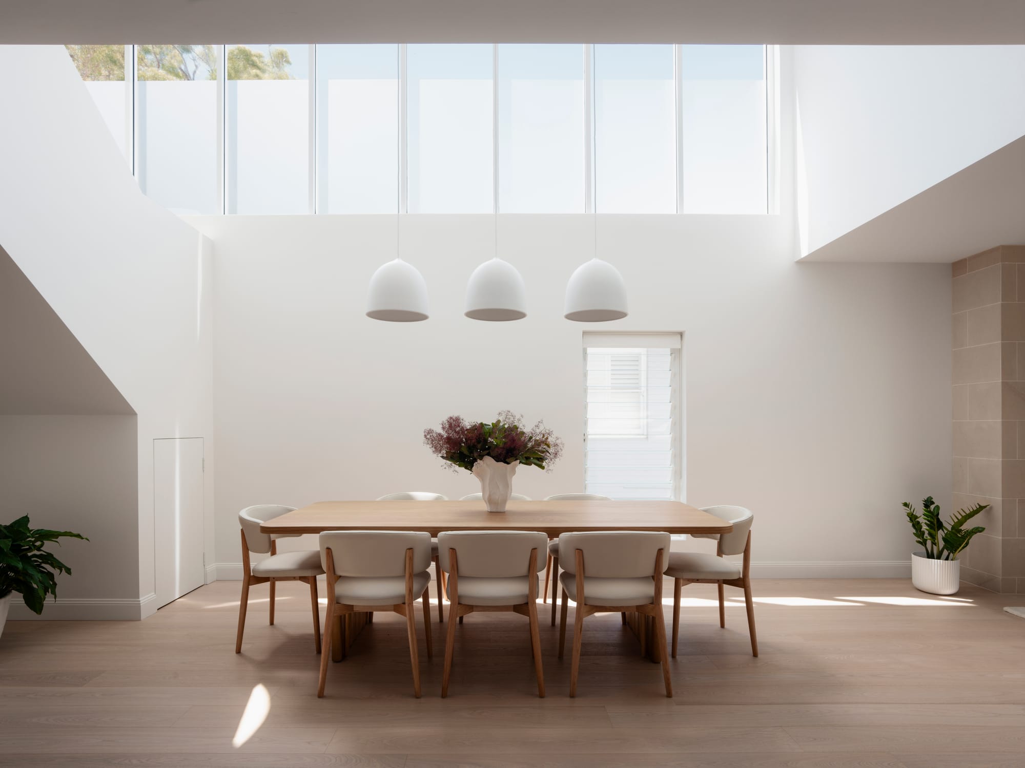 Sienna House by 868 Architects. Photography by Luke Butterly. Facade of double-storey contemporary home with white panelled upper level. 