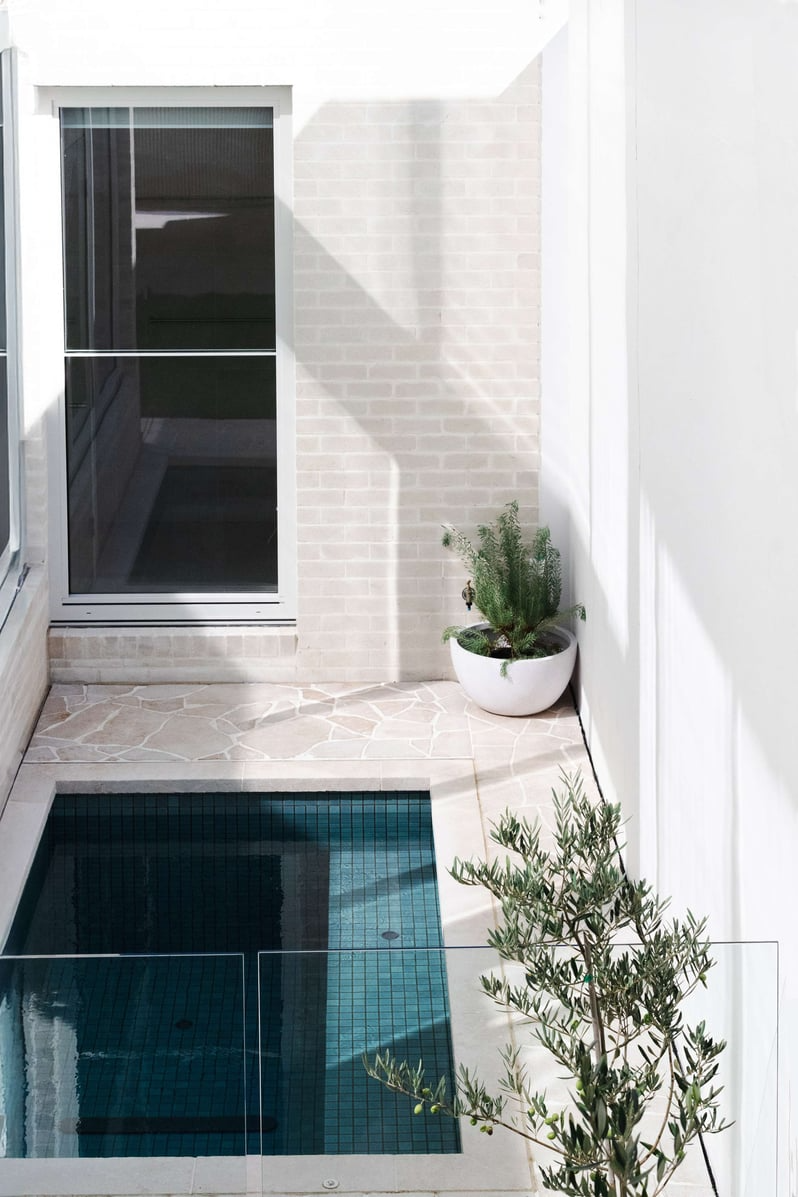 Richmond Heritage Extension by Archive. Photography by Tessa Carroll. Exterior courtyard with paved floors, tiled pool and light brick walls. 