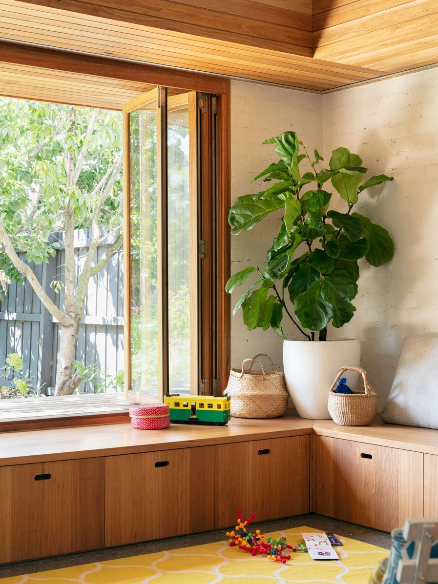 Elm Street House by Gardiner Architects. Photography by Rory Gardiner. Timber joinery and bench seat, overlooking garden through folding window. 