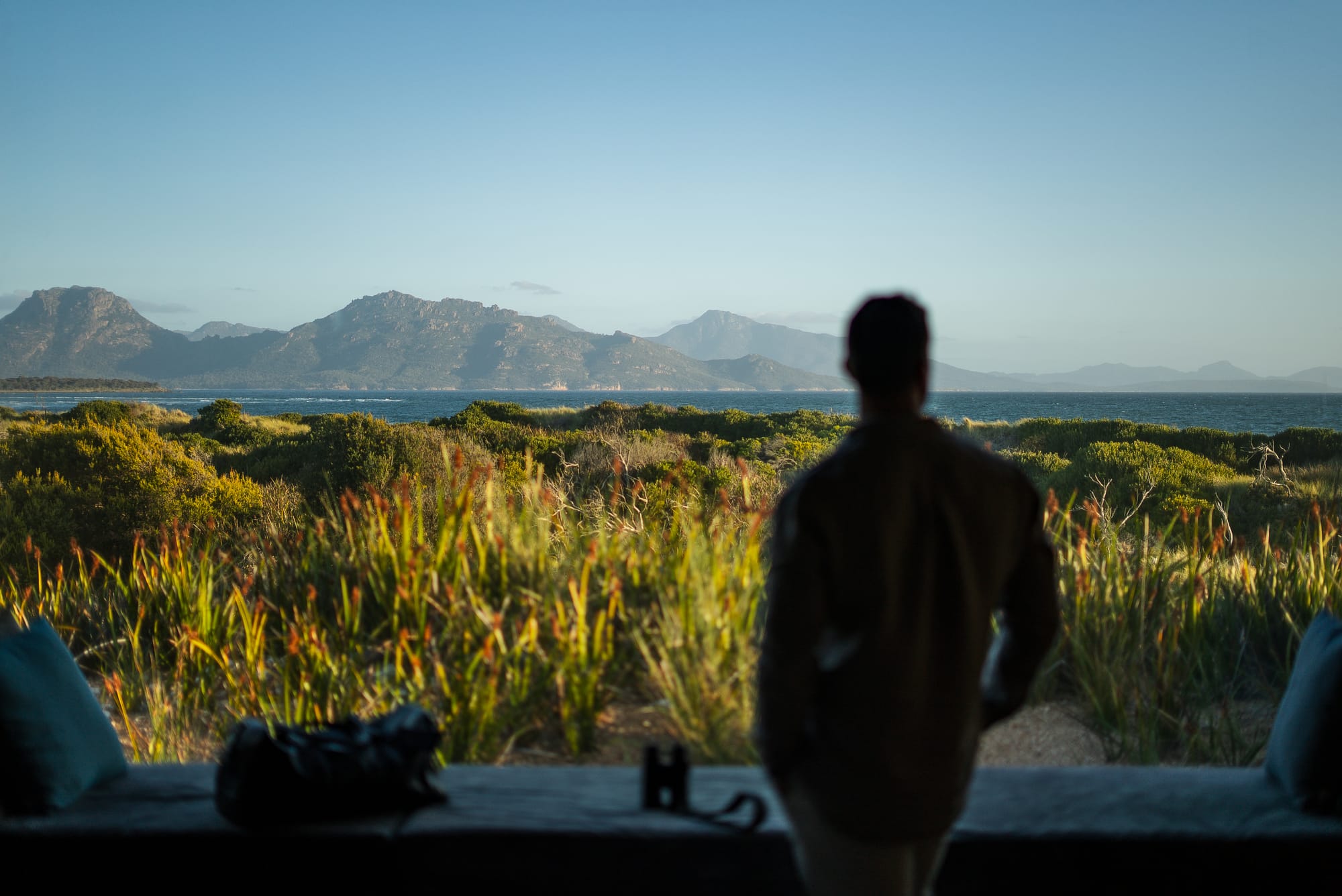 An interior view of Studio Tasmania showing a man looking out to the coastal landscape.