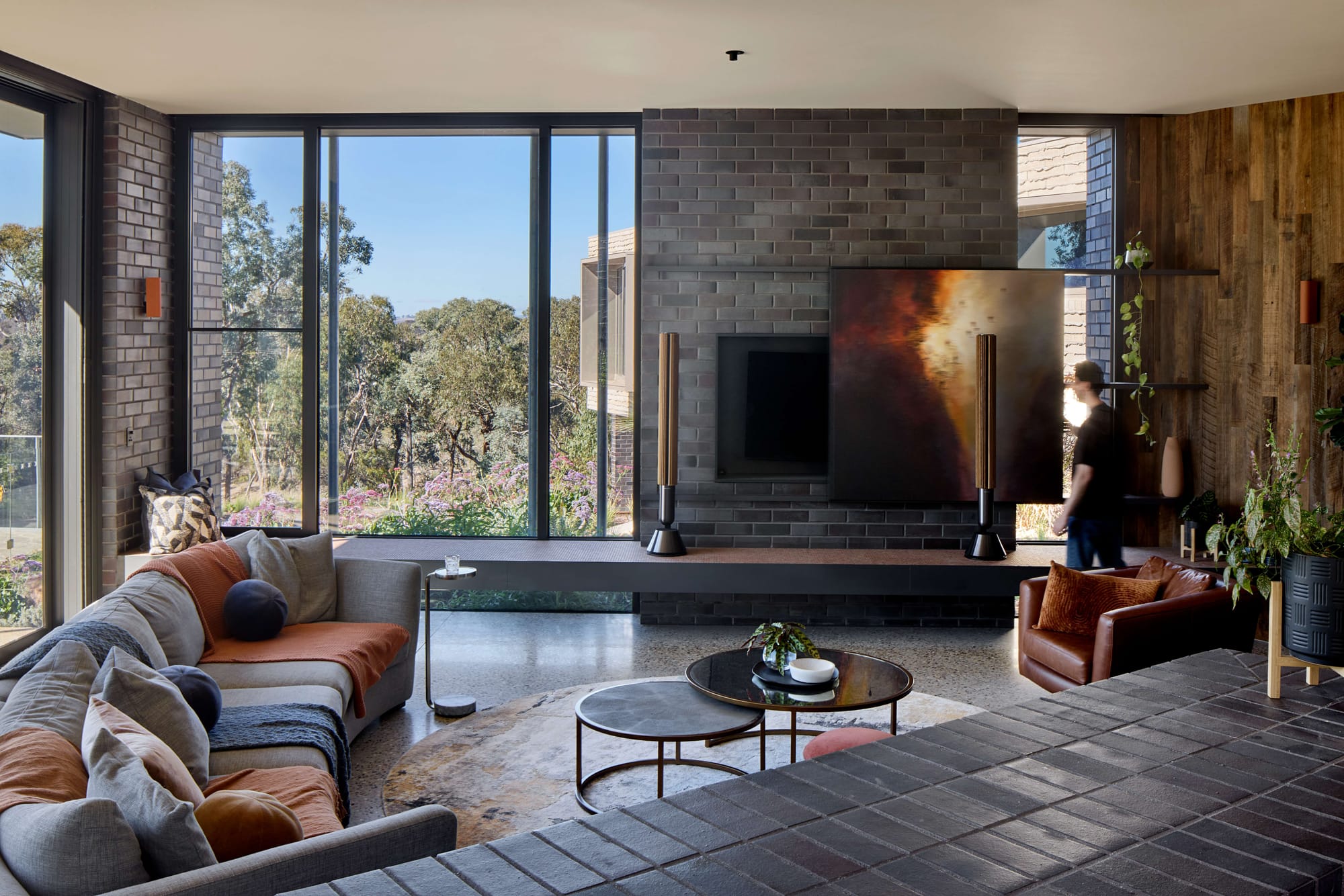 Native garden entry with layered planting, textured brickwork, and contemporary black steel detailing.