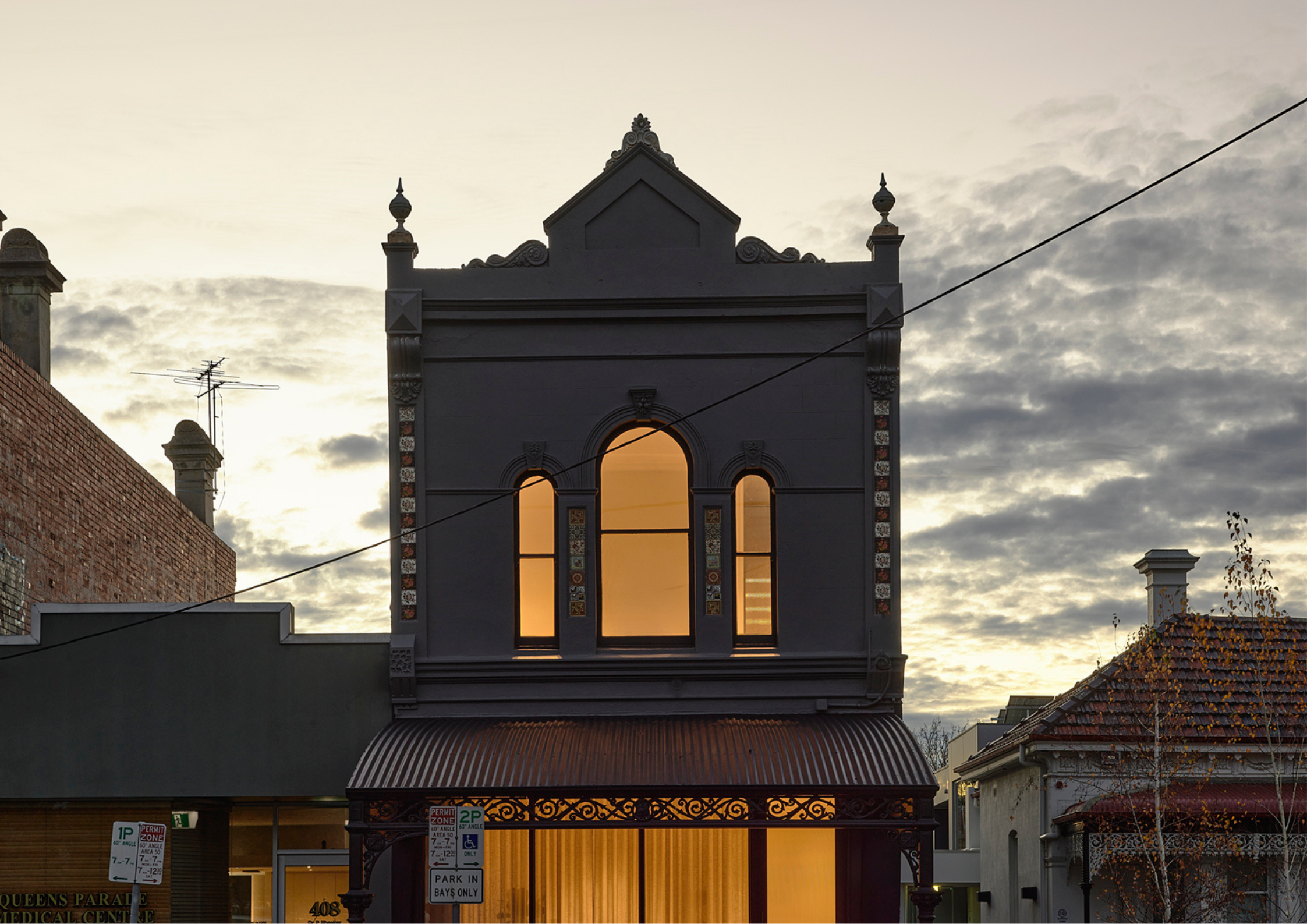 Haka House by Taouk Architects showing the exterior street facade of red and brown brick and timber.