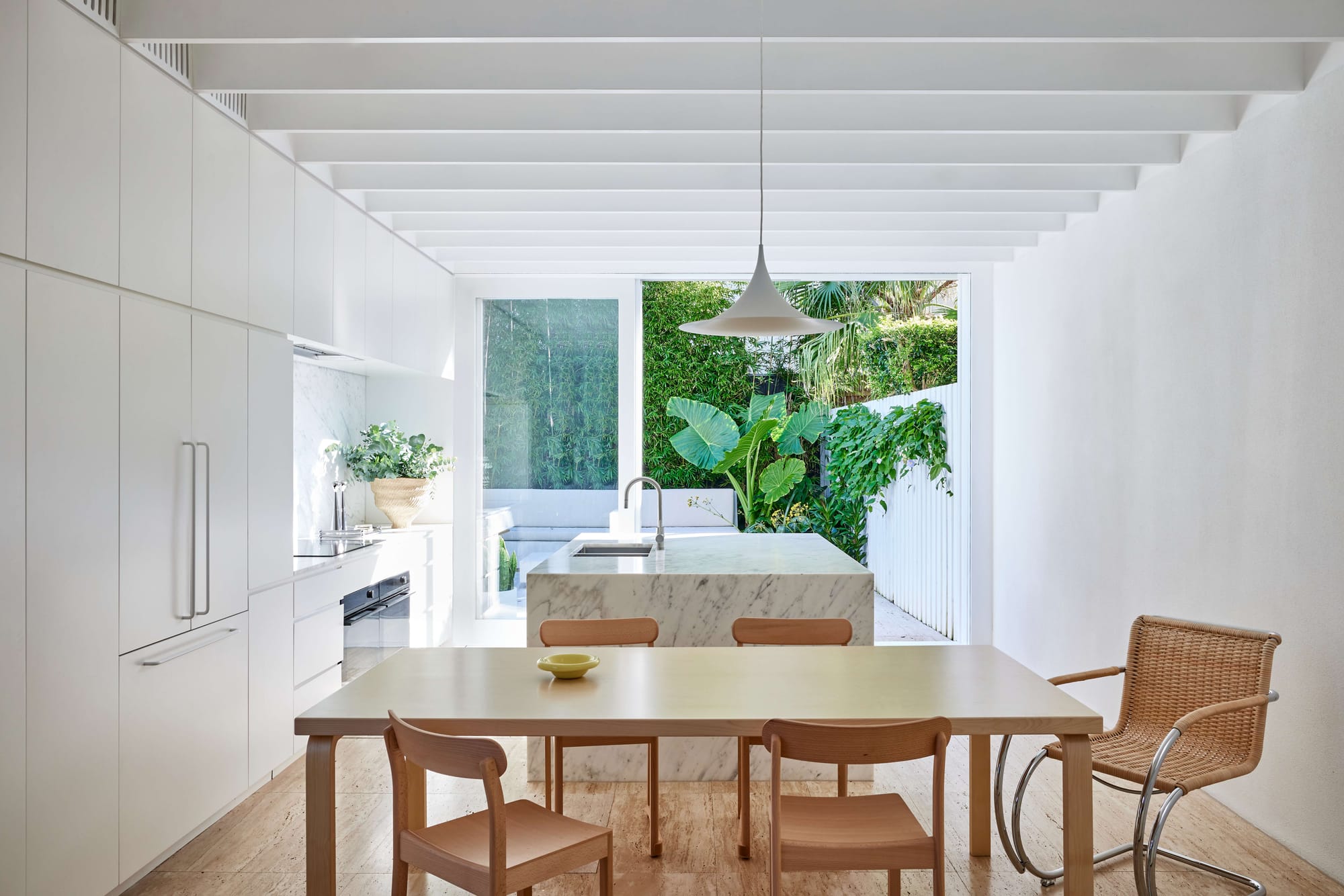 White pitched-roof addition with louvred shutters and dry cactus garden, North Bondi House by Studio Arkive