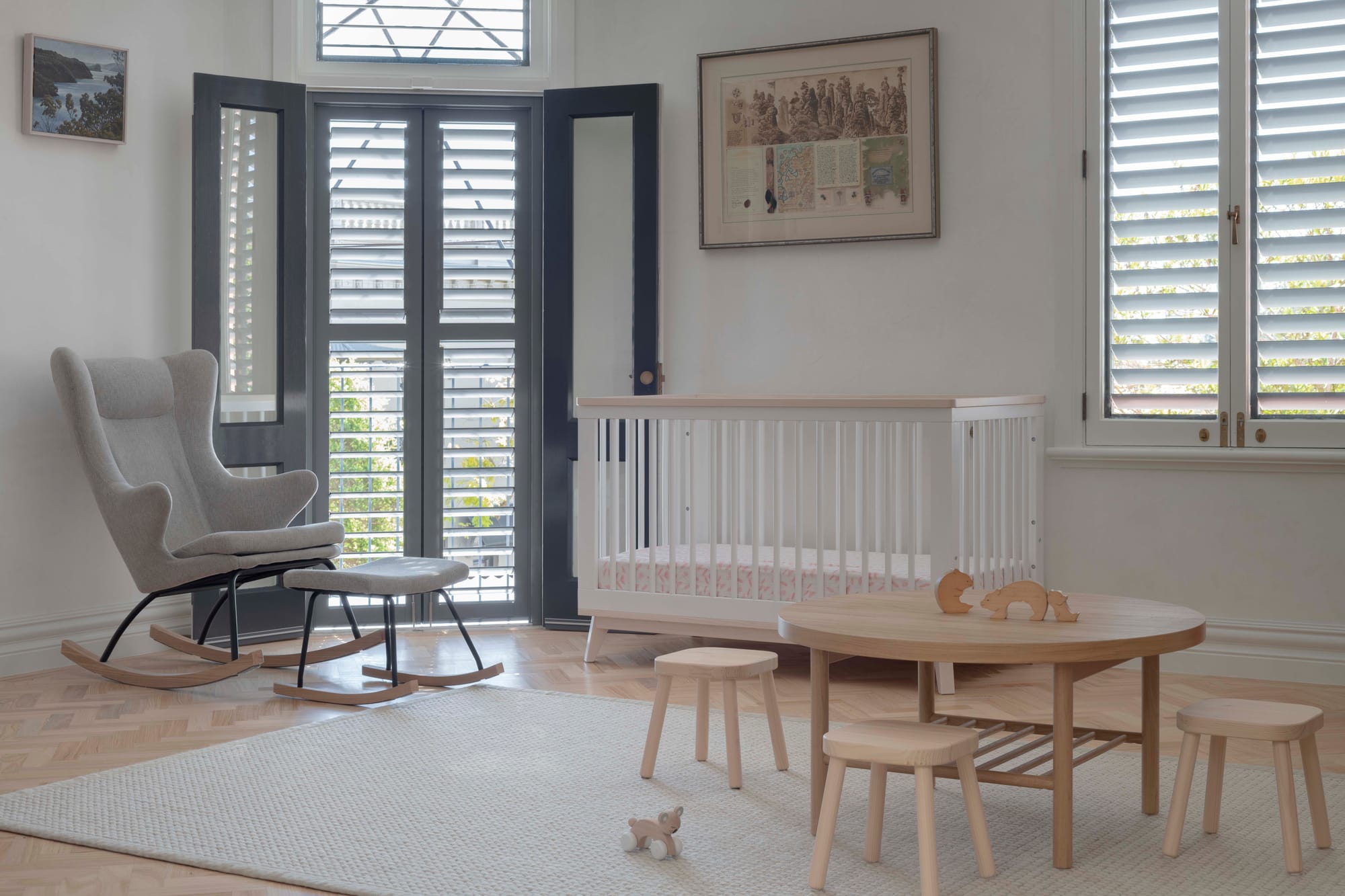 Nursery with white timber cot, rocking chair, herringbone parquet floors and plantation shutters, Paddington Twin Terraces by Studio Dewar