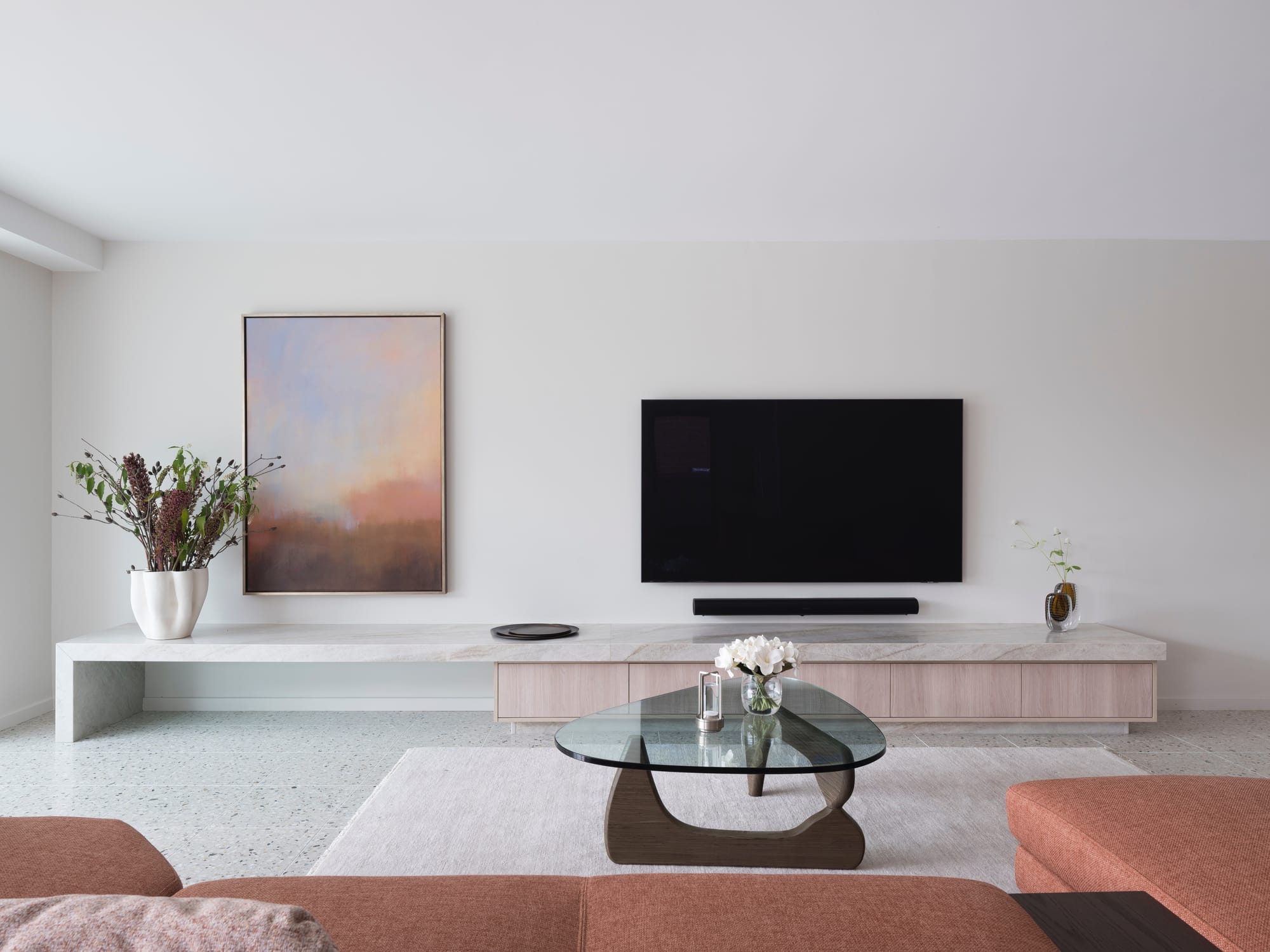 Calm living room with travertine media console, Noguchi coffee table and abstract artwork, Queen Street Mosman by McNally Architects