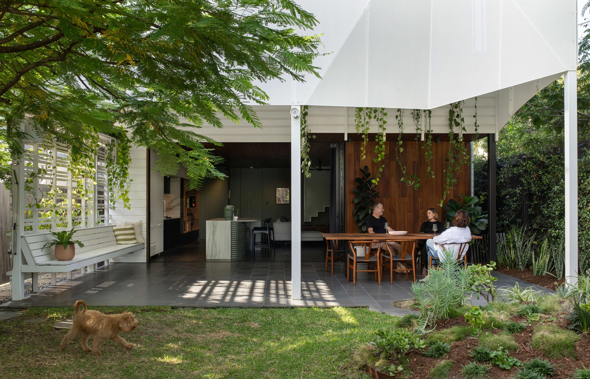 Covered outdoor dining area opening to the kitchen and landscaped garden at Cornerstone by LOUPE Architecture. Photography by Alanna Jayne McTiernan.