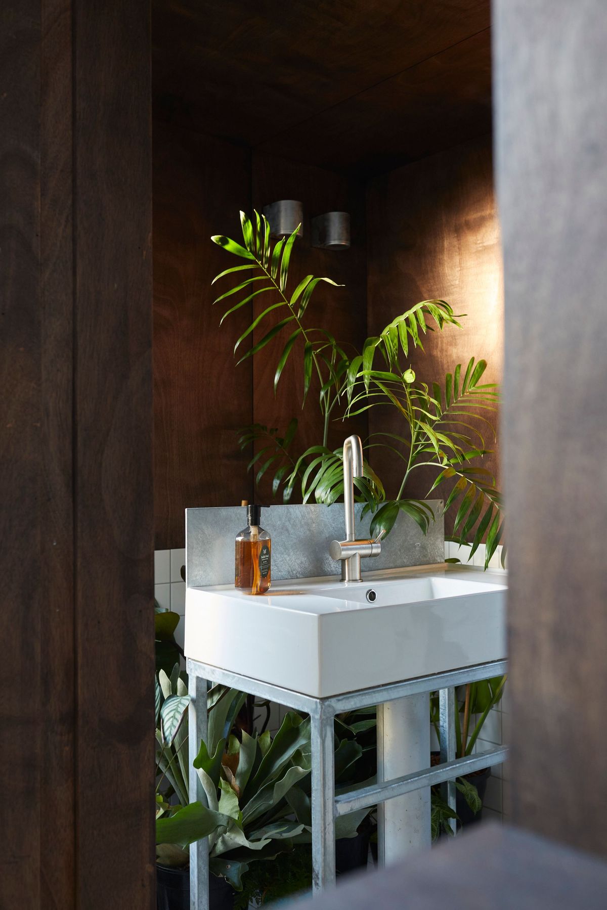 An interior shot of the basin of DEN PLACE showing the basin and indoor plants