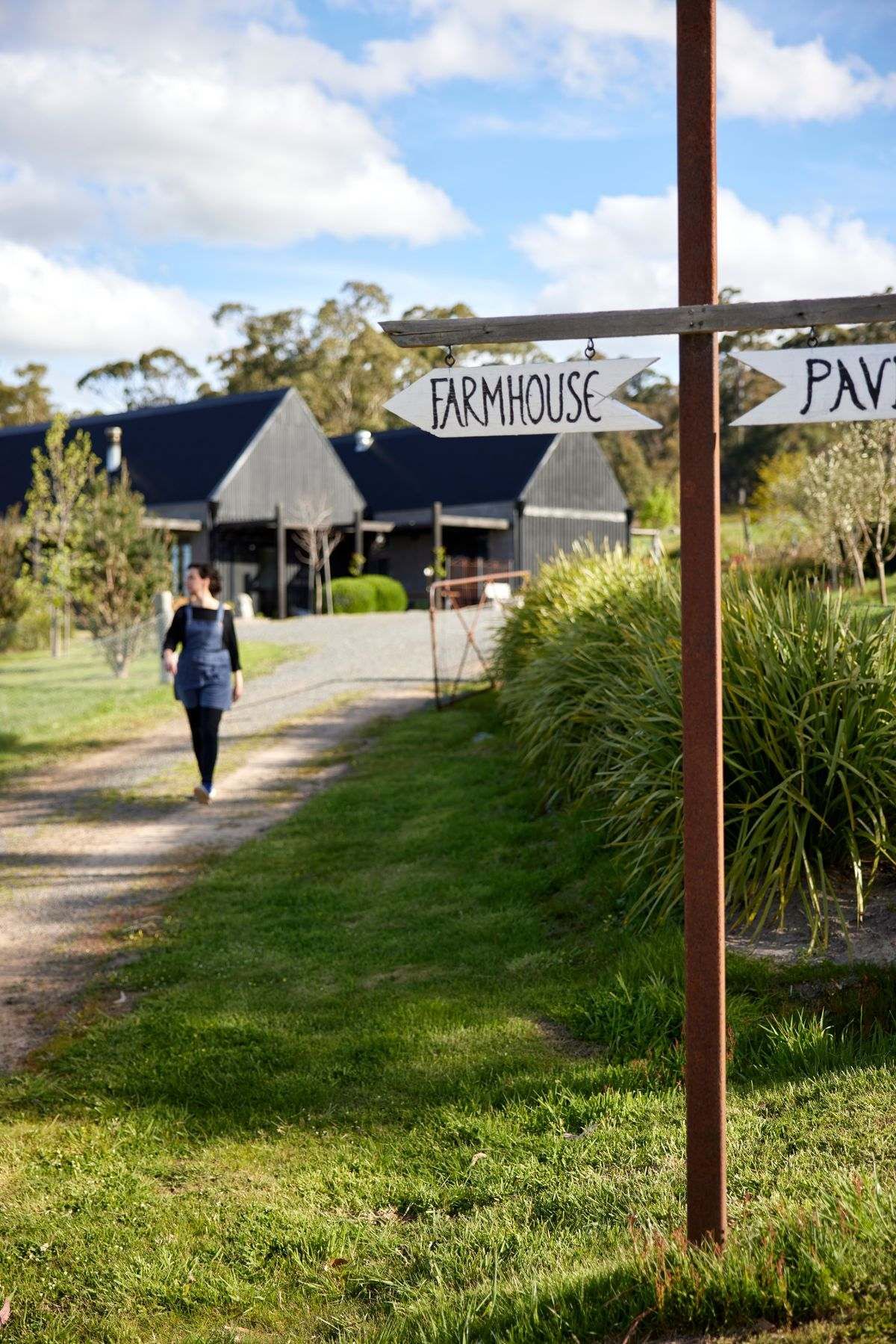 Landscaped entry to The Glut Farm. A sign pointing to the farmhouse