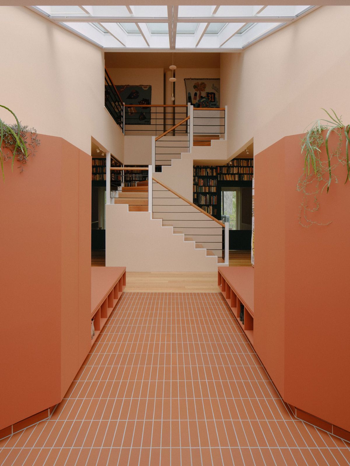 Selby House by Placement. Photography by Tom Ross. Entry to residential home framing staircase and second story interior balc
