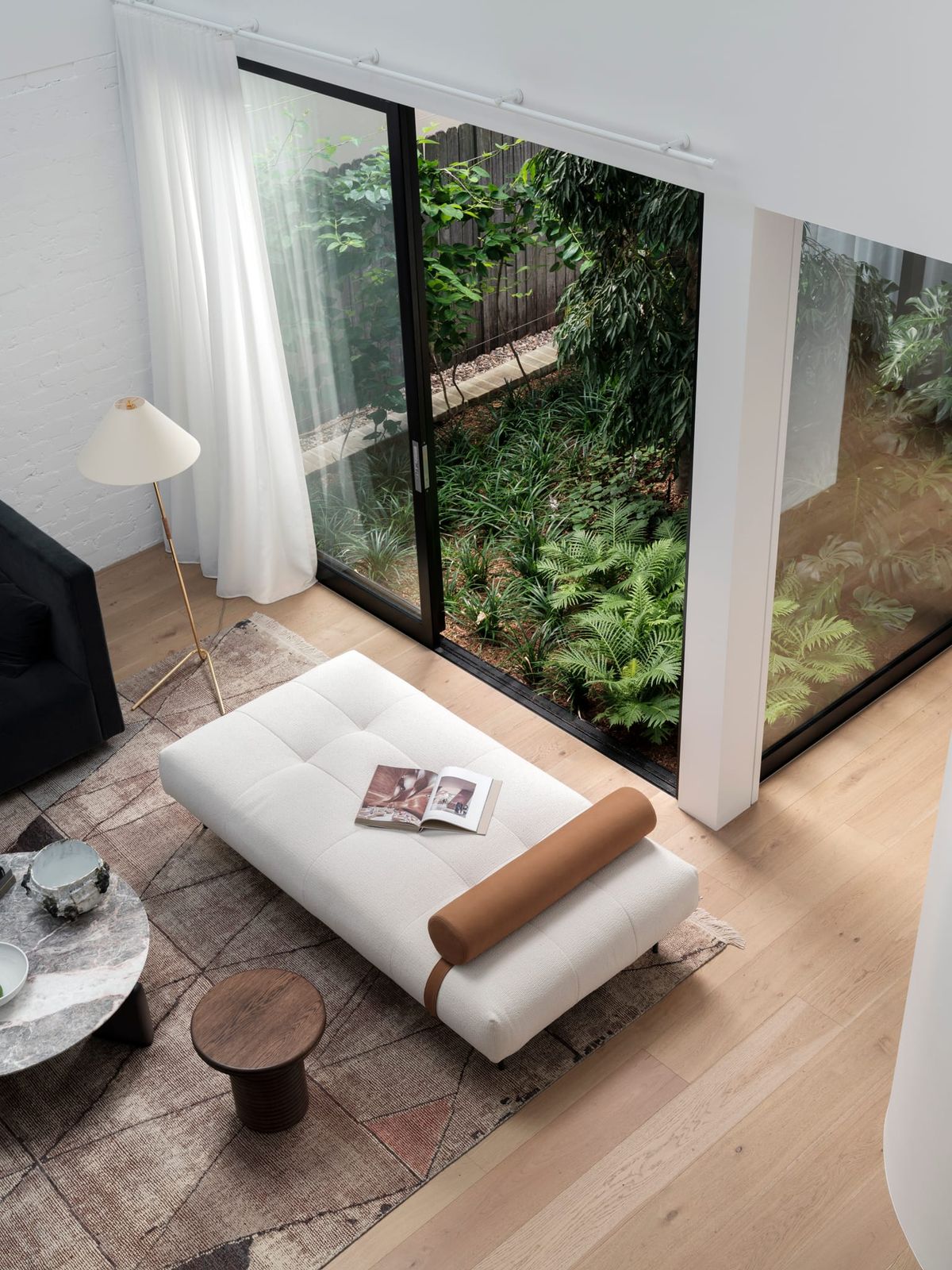 Bellevue House by Carla Middleton Architects. Photography by Tom Ferguson. High angle of living room with timber floors. 
