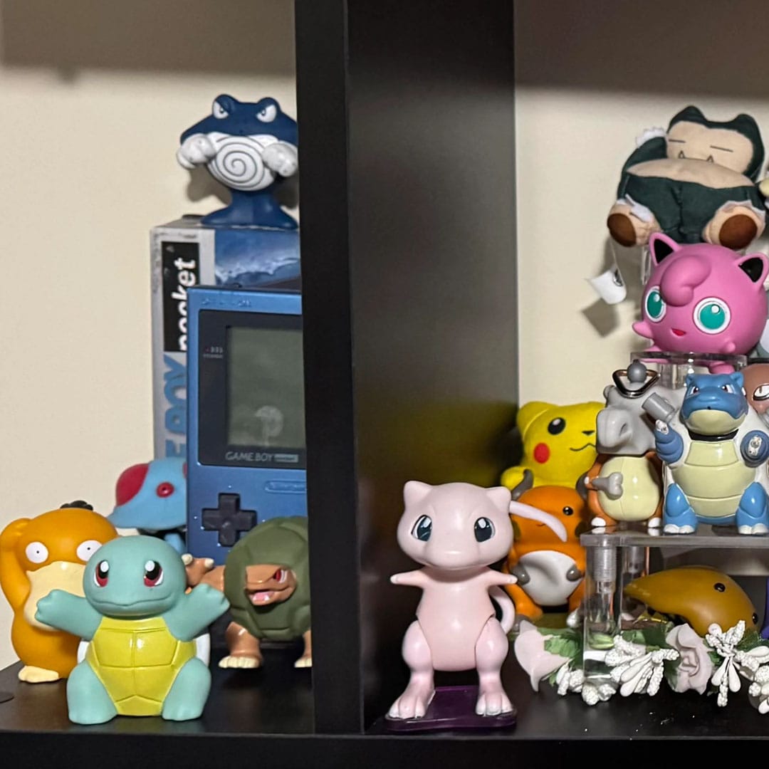A close up of Mew and Squirtle Pokémon figurines from Burger king with others in the background