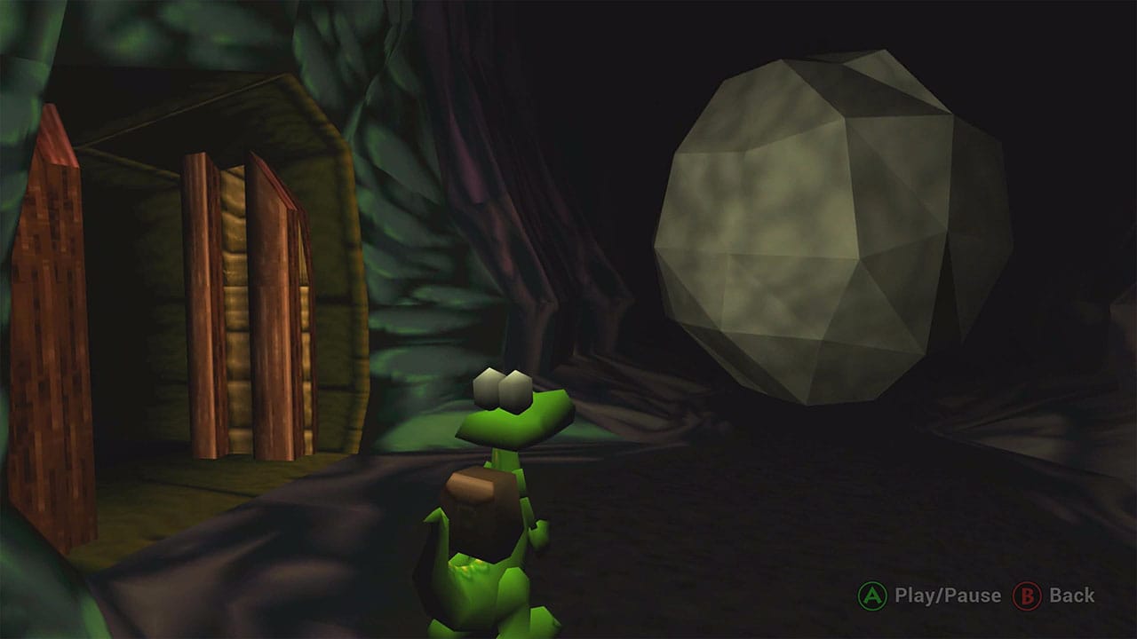 Croc looking at a big boulder