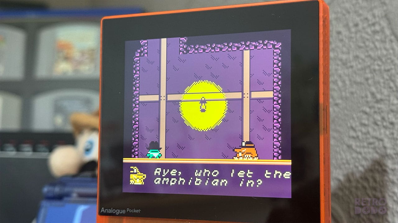 A frog in a cowboy hat about to battle a mole