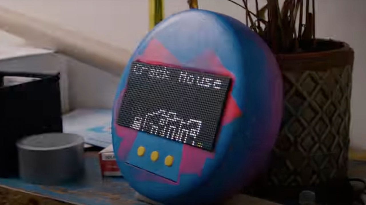 A giant Tamagotchi with an image of a house on it