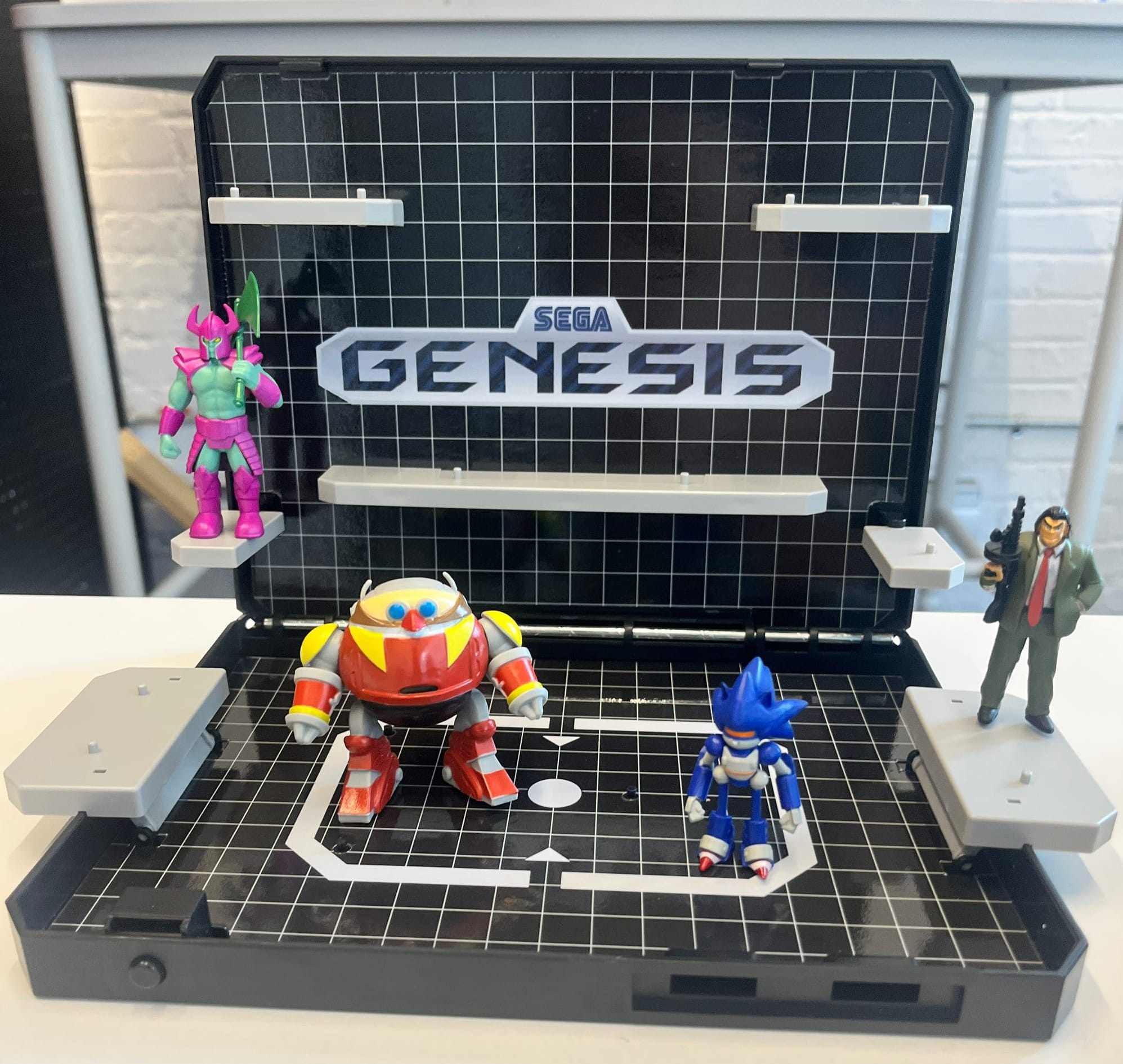 A clamshell diorama of the Sega Genesis