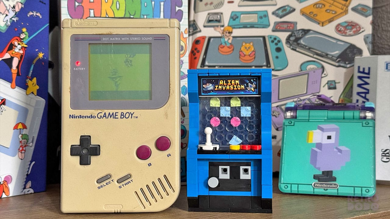 A toy arcade cabinet next to a Game Boy DMG