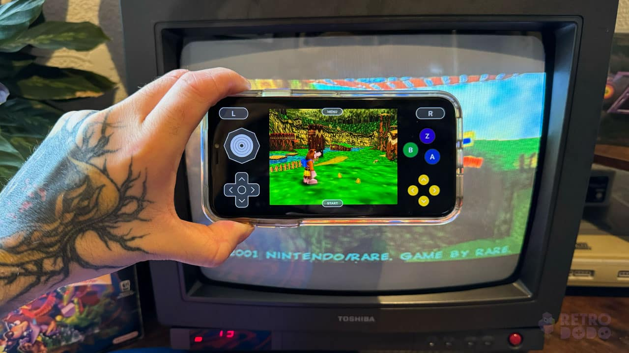 Seb holding his iPhone in front of a CRT TV