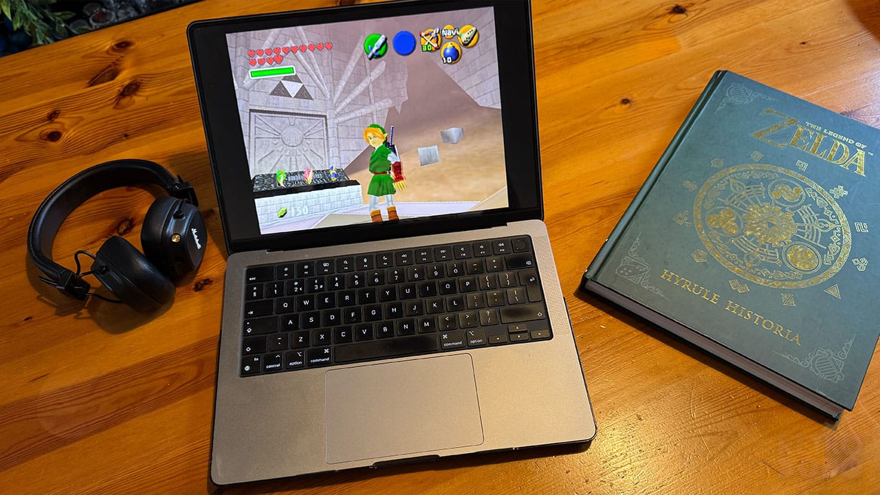 Adult Link in the Sealed Palace on Seb's laptop, next to some headphones and the Hyrule Historia book
