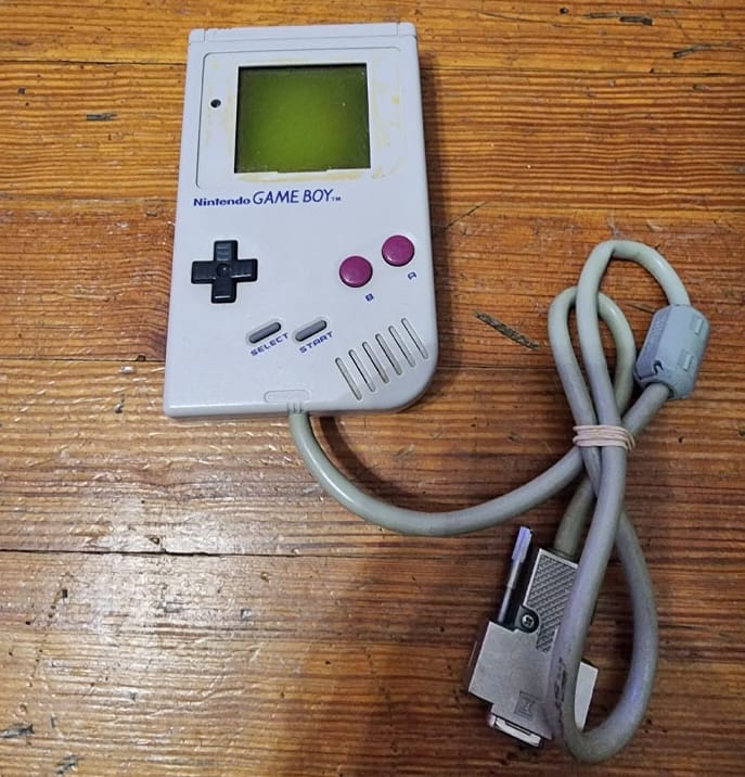 Game Boy with a connector wire attached. 