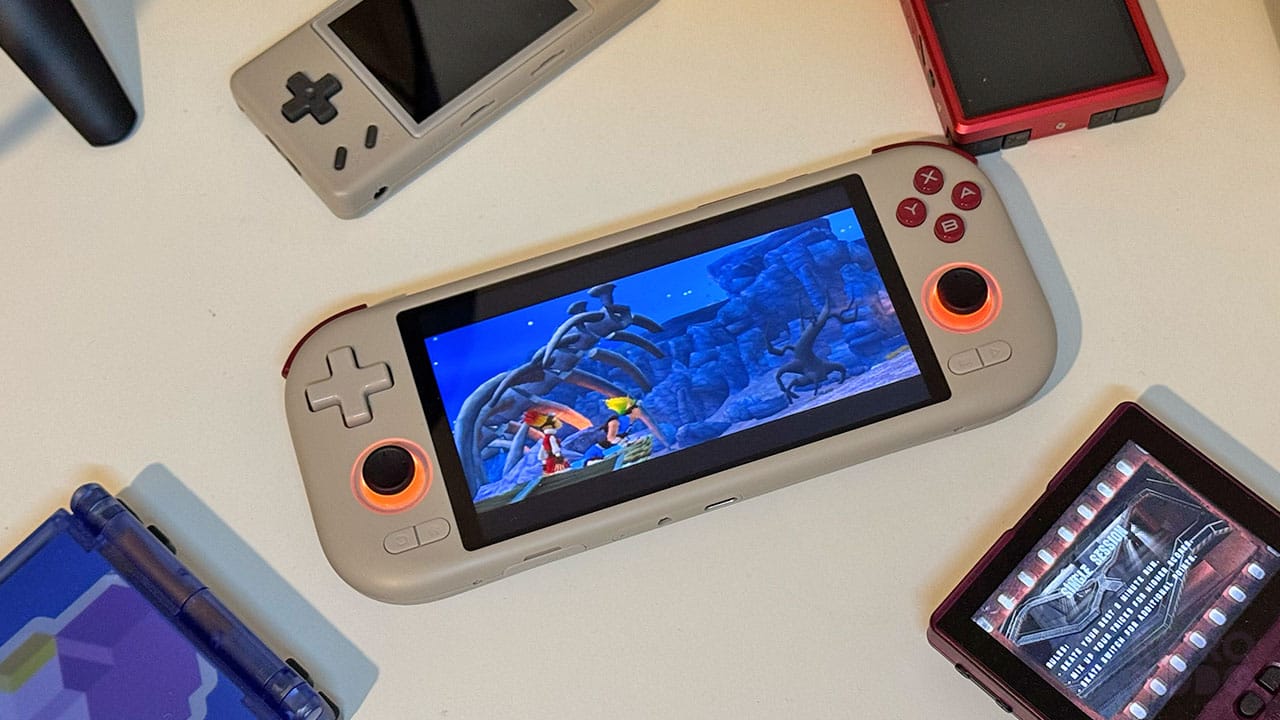 A grey handheld in the middle of other handheld gaming consoles