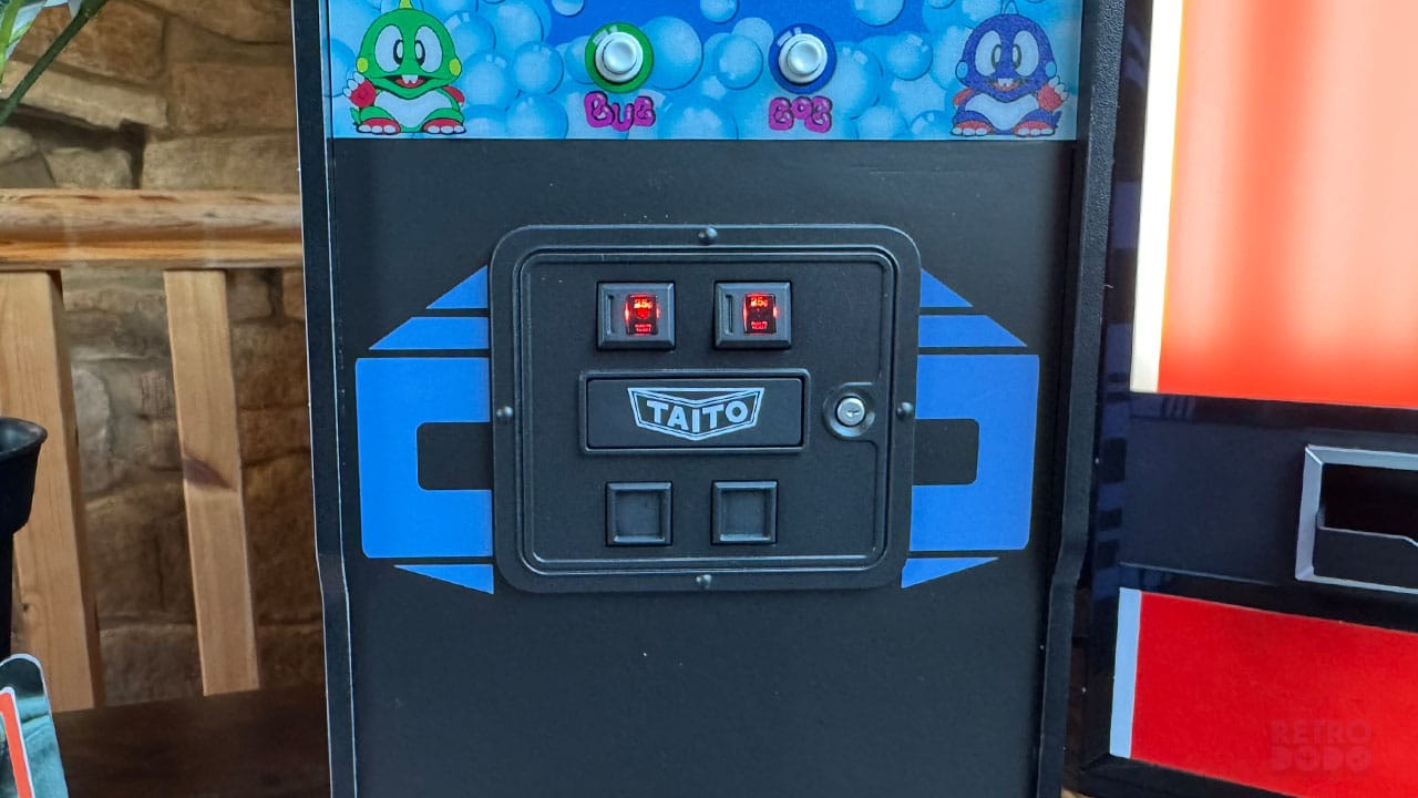 Coin slots and Taito logo