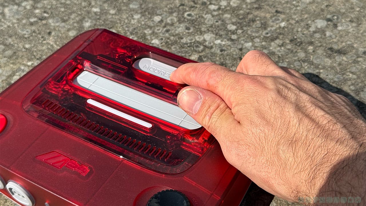 Seb pushing down the eject button on the console