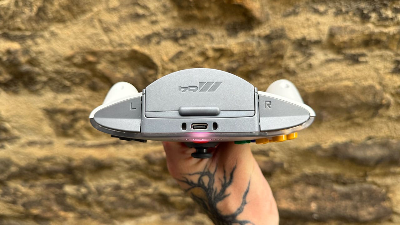 Seb holding the M64 controller and showing off the shoulder buttons