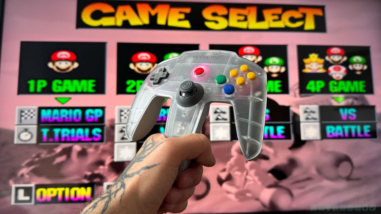 Seb holding up the controller in front of Mario Kart