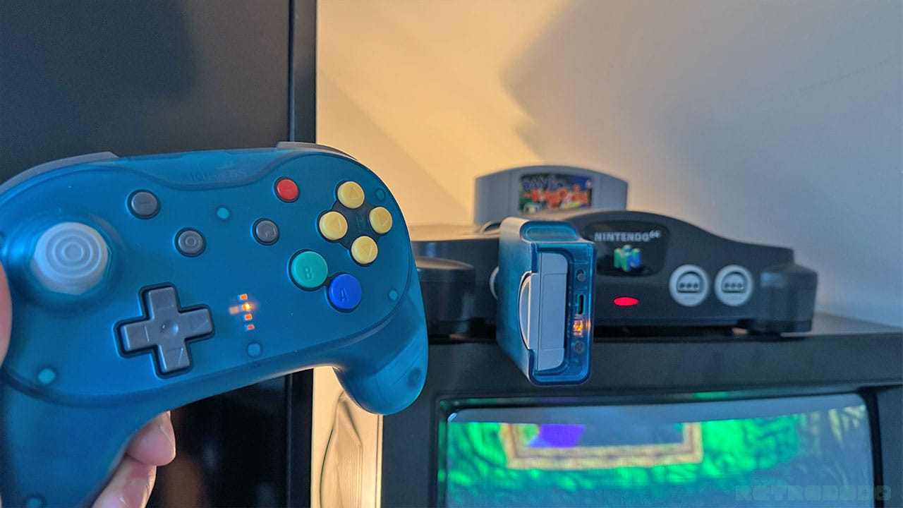 Seb holding a controller next to his N64