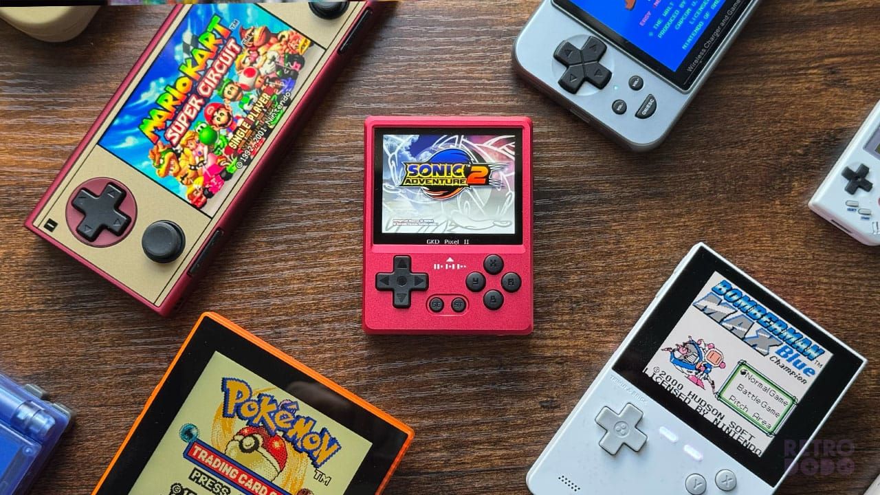 The GKD Pixel 2 on a table next to other retro handhelds