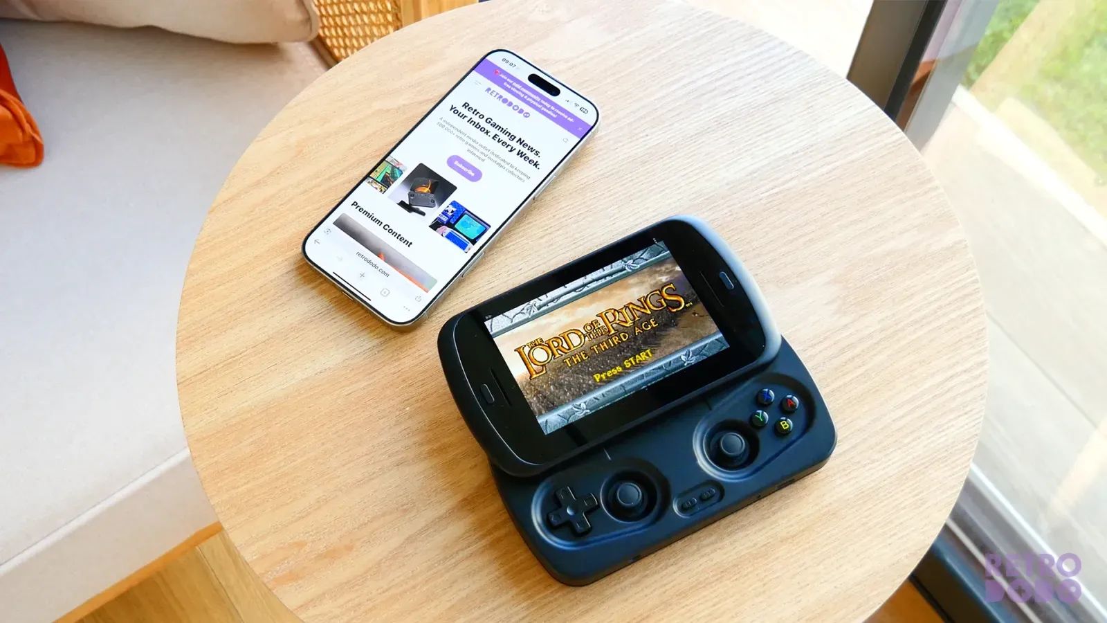 A sliding handheld next to an iPhone