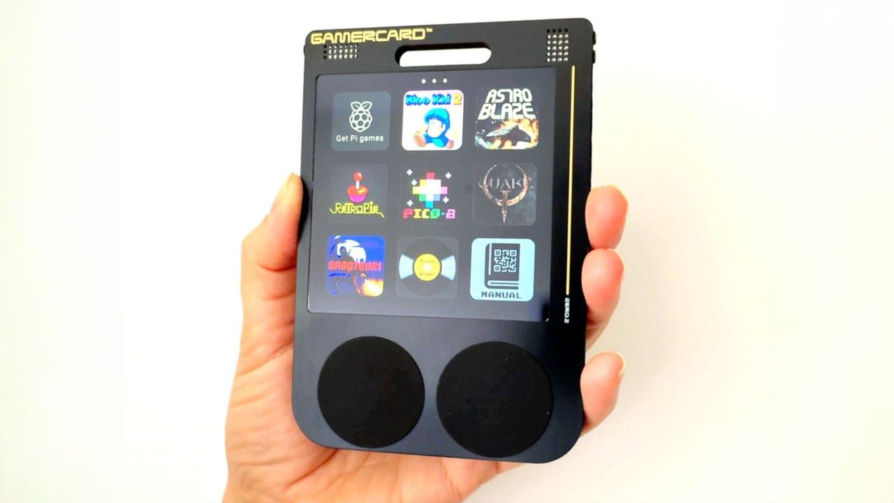 A hand holding the GamerCard handheld