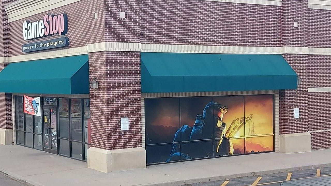 A corner shot of a GameStop store with a Halo mural