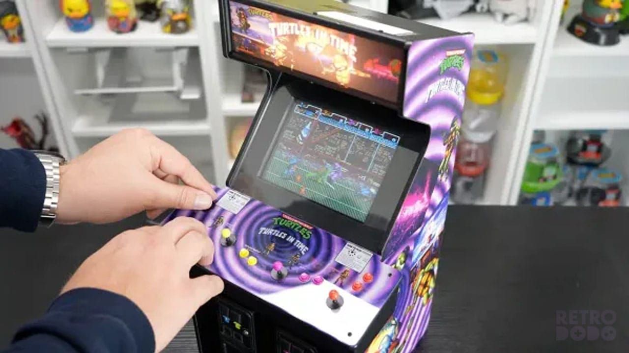 Brandon playing on a mini arcade cabinet