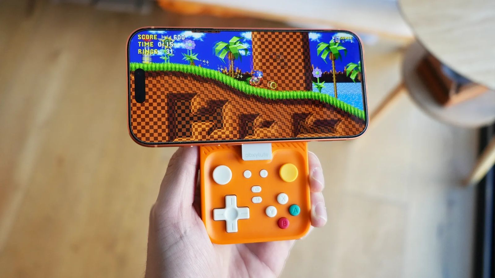 M4 featured image - orange controller with an iPhone showing Sonic gameplay