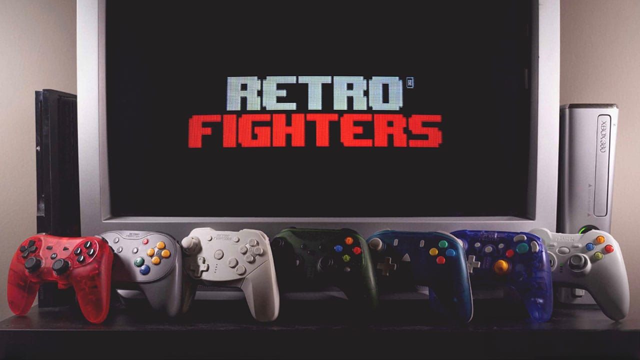 Multiple Retro Fighters controllers underneath a TV showing the Retro Fighters logo