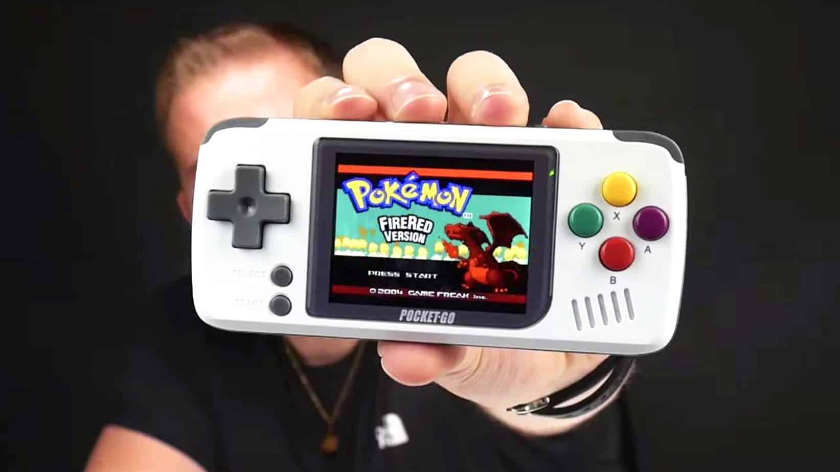 Brandon holding a Pocket Go in his hand playing Pokemon FireRed