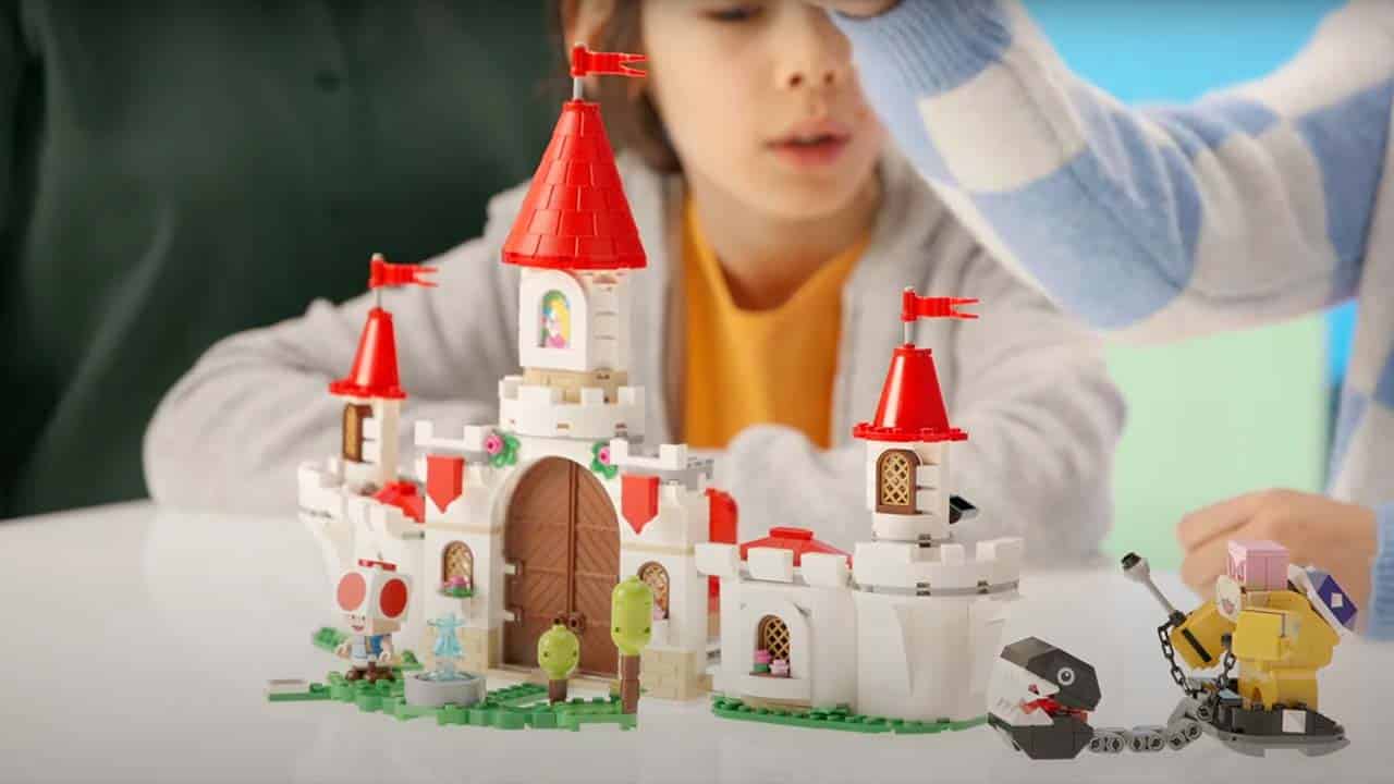 Two children playing with the new Battle With Roy at Peach's Castle LEGO set 