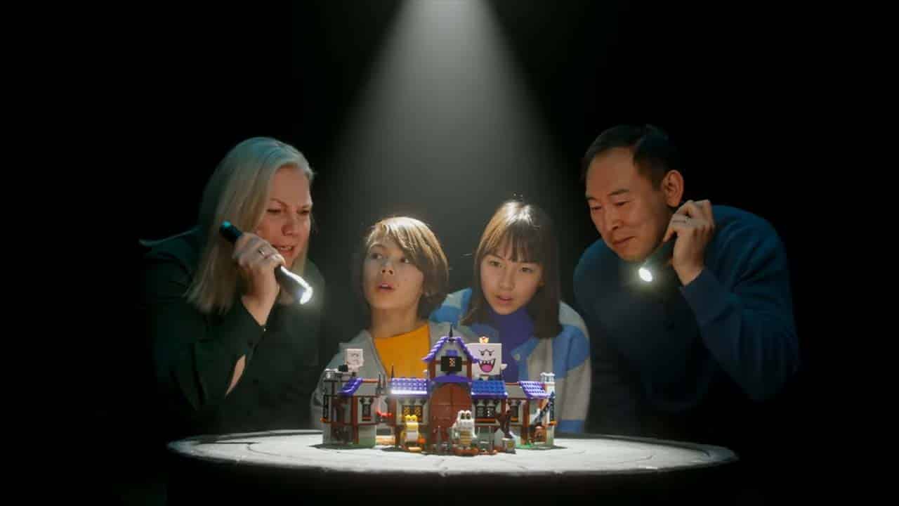 LEGO King Boo's Haunted Mansion set. A family is illuminating it with torches