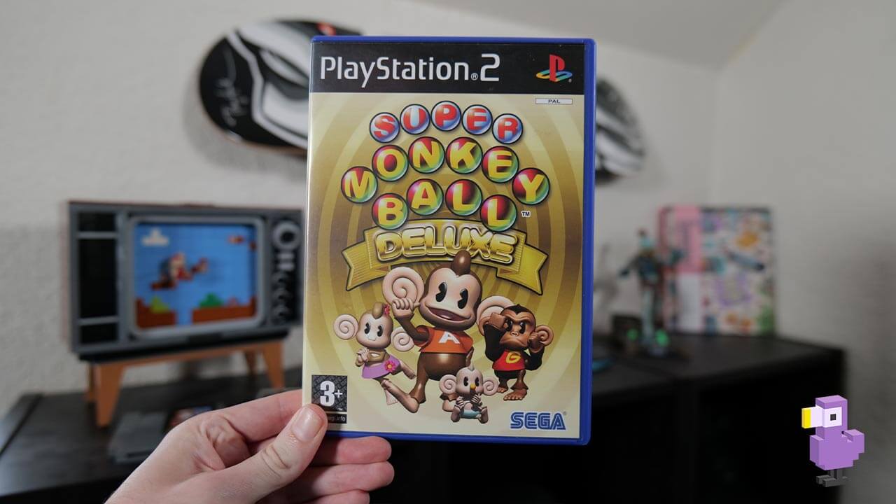 Rob holding a copy of Super Monkey Ball Deluxe for the PS2
