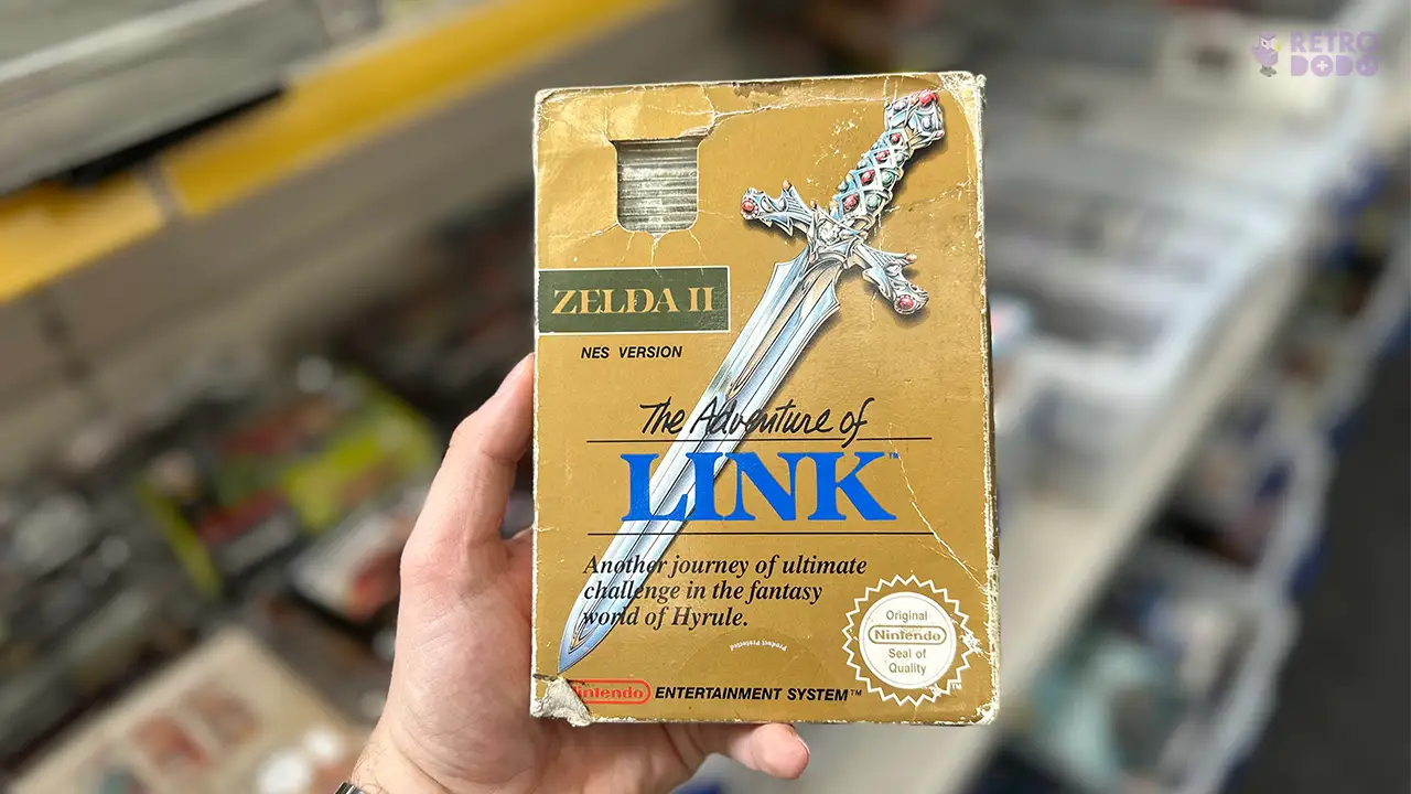 Brandon holding a copy of Zelda II: The Adventure of Link for the NES