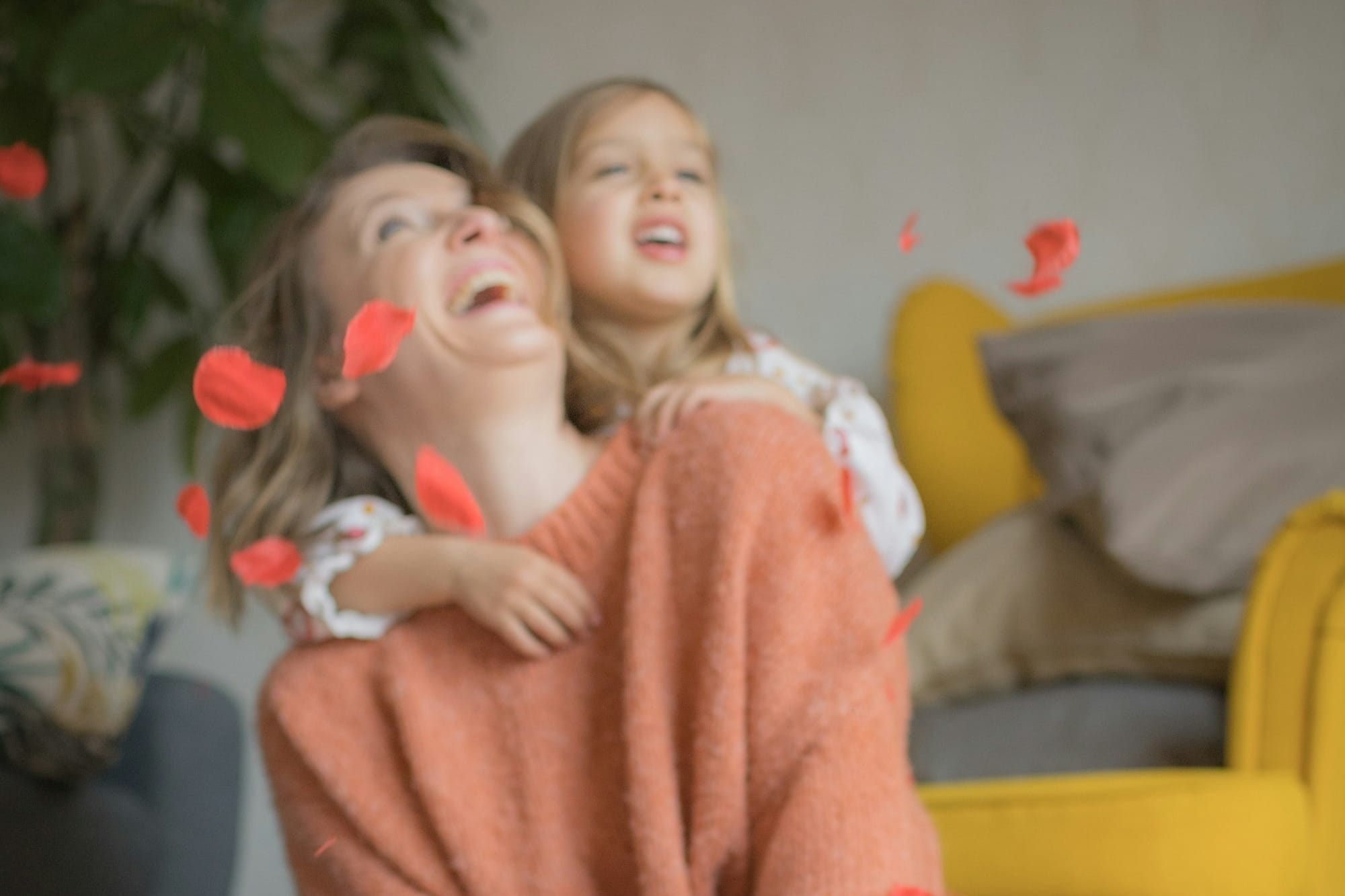 woman in pink sweater and blue denim jeans sitting on floor