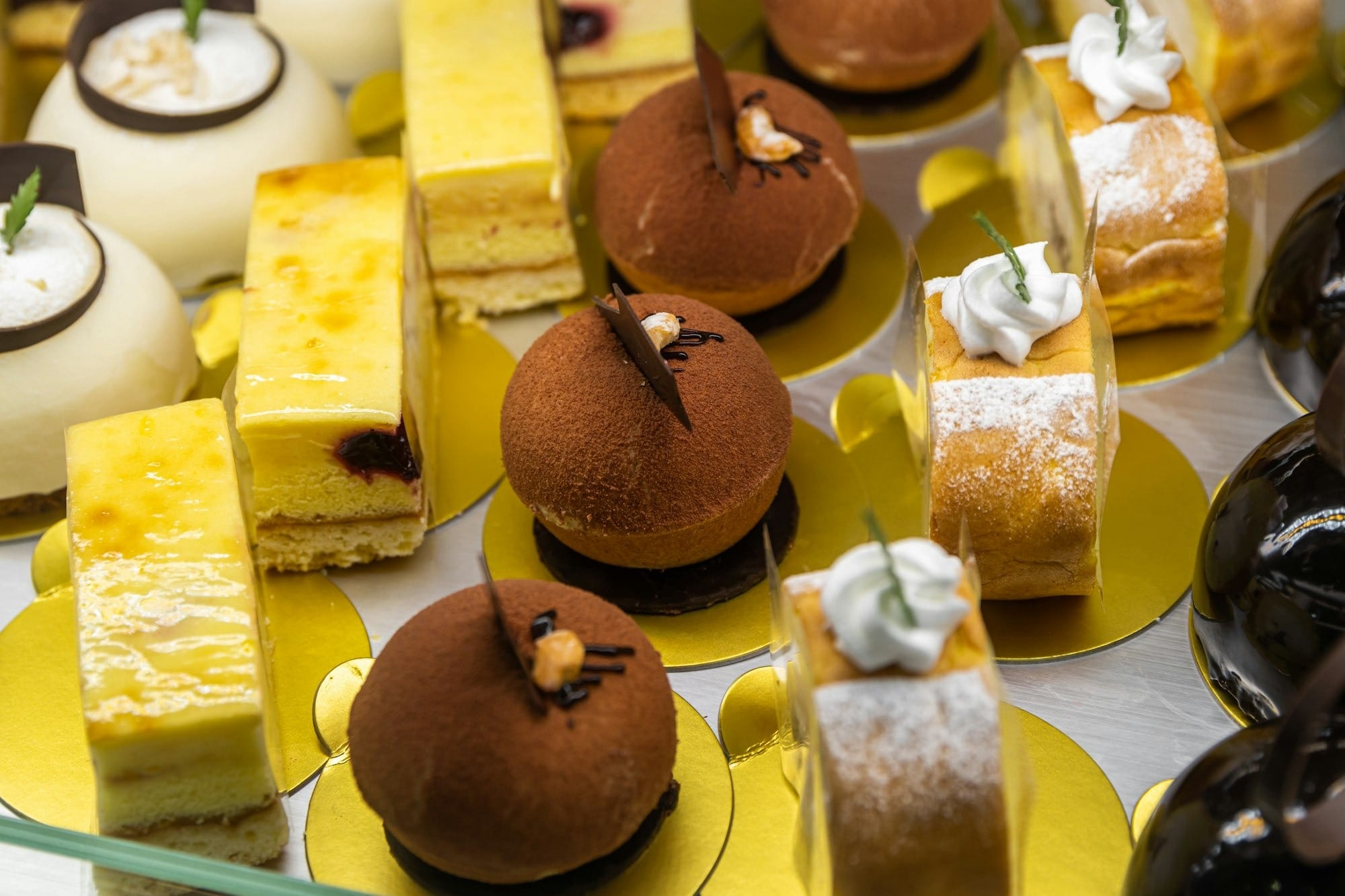a table topped with lots of different types of cakes
