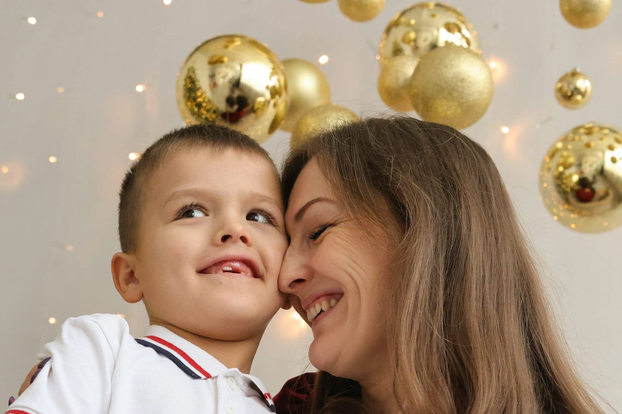 A woman sitting next to a little boy