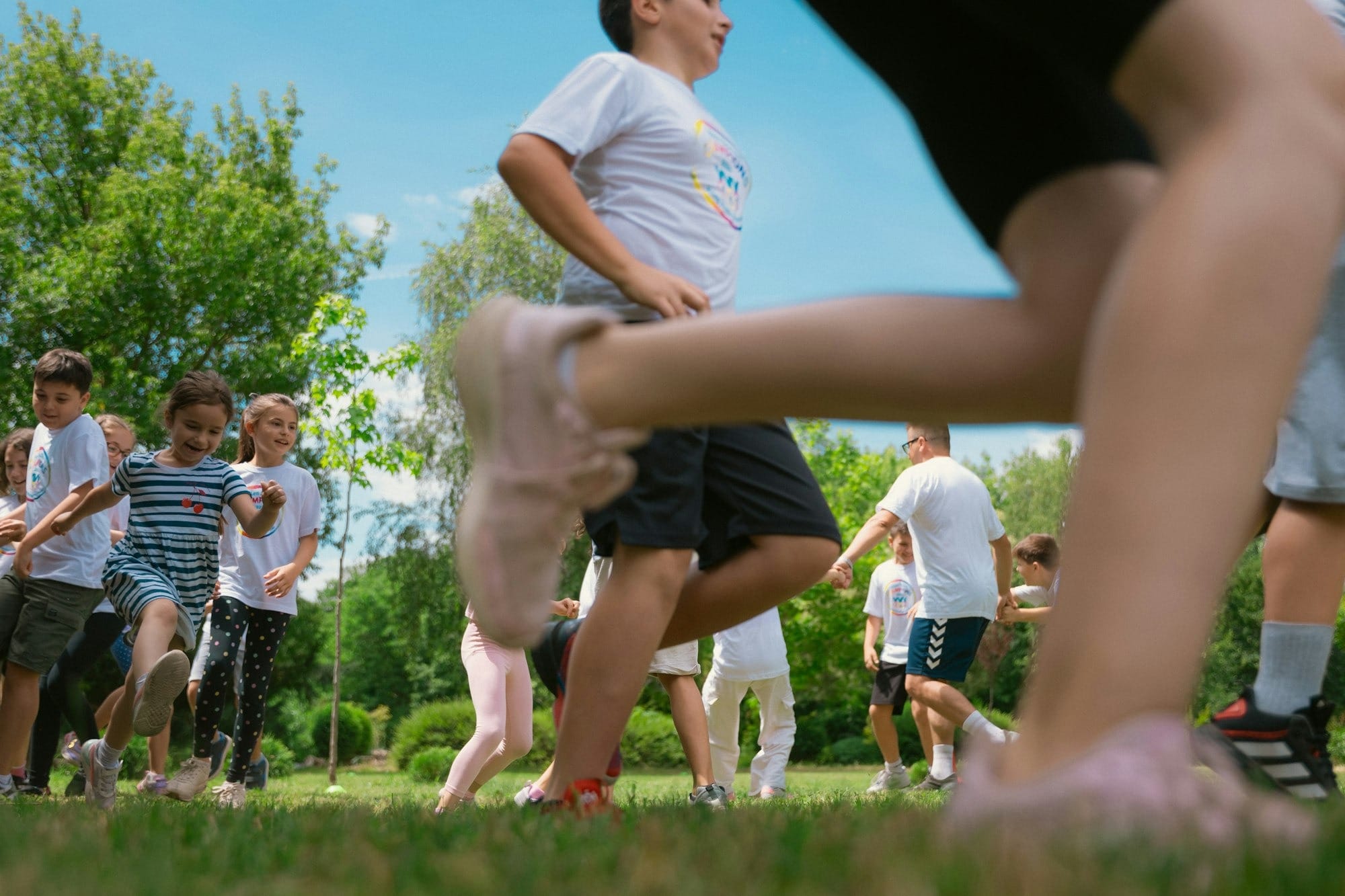 a group of young children playing a game of frisbee