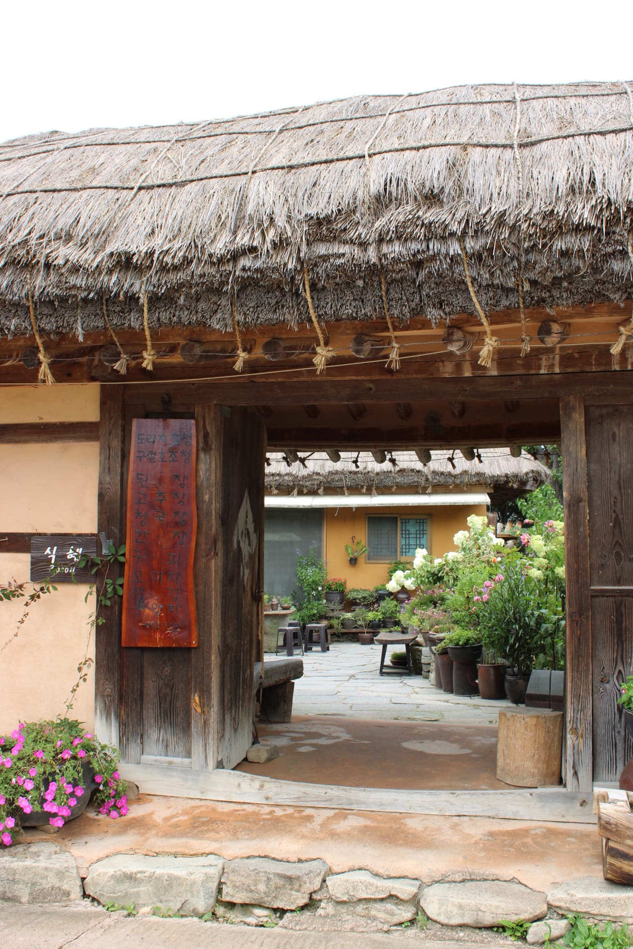 OeamFolkVillage_CreditAsheyWhitten_Door Gateway view with Korean lettering, courtyard, Oeam Folk Village