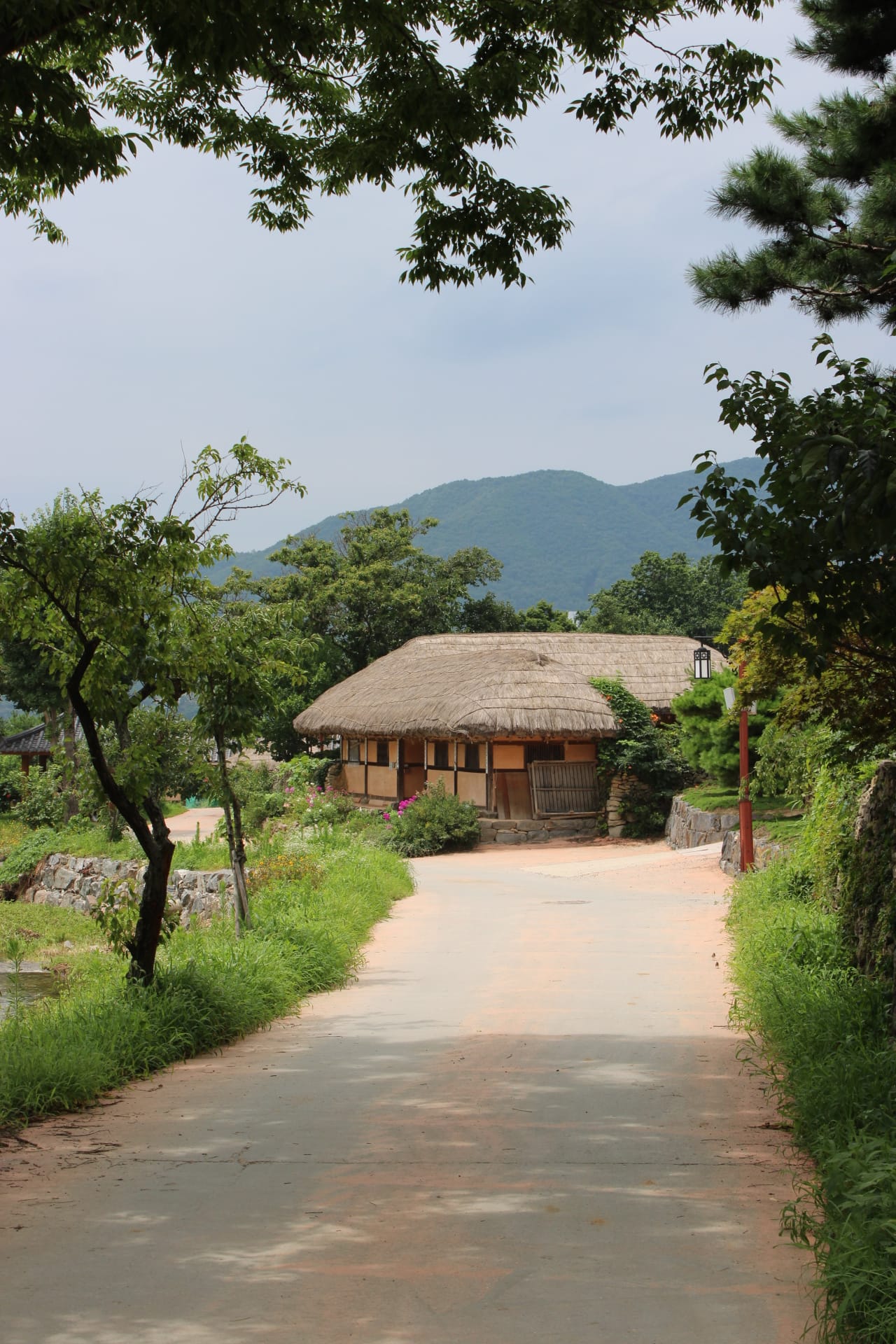 OeamFolkVillage_CreditAsheyWhitten_Road_House Path leading to a thatched-roof house, Oeam Folk Village Asan
